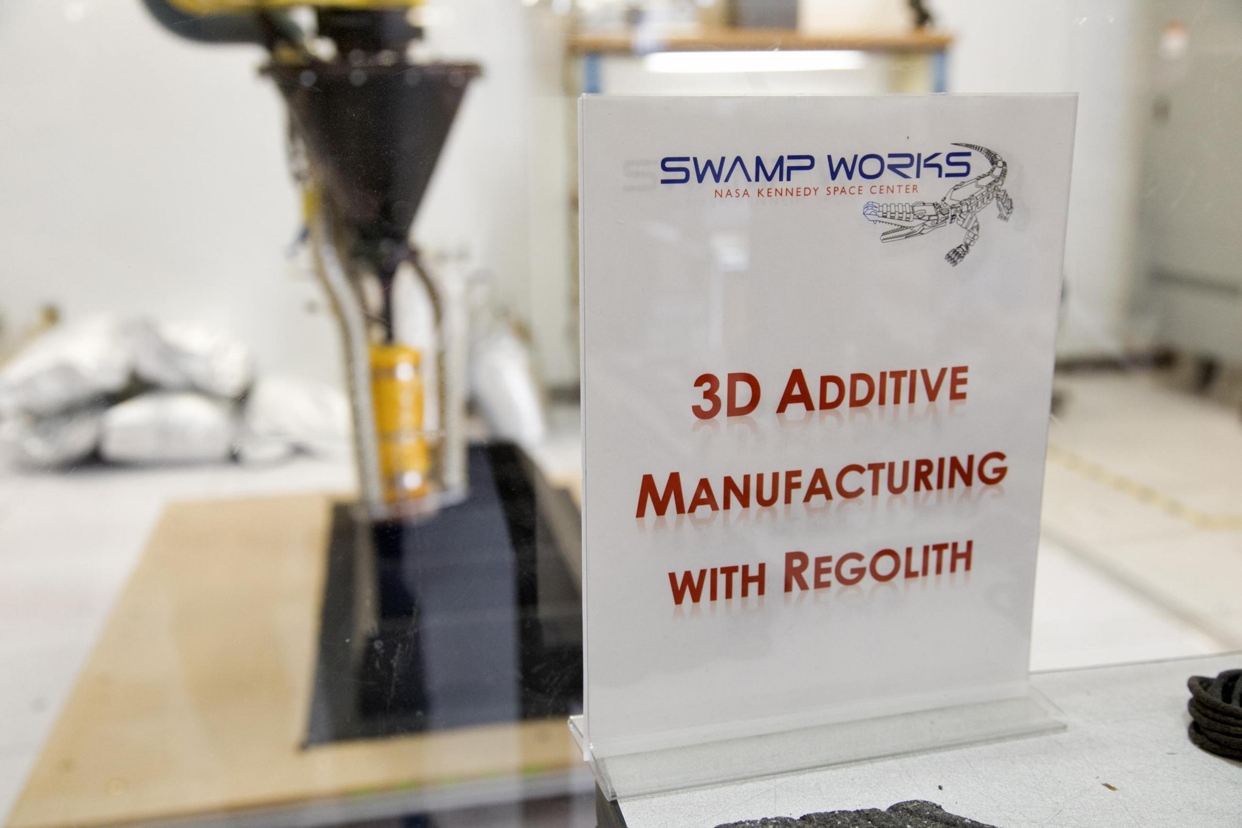 The 3-D printer used to make things out of lunar dust (regolith) at the Kennedy Space Center.  Additive manufacturing is another name for 3-D printing.